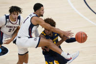 West Virginia's Miles McBride (4) makes a pass while being defended by Gonzaga's Jalen Suggs (1) during the first half of an NCAA college basketball game Wednesday, Dec. 2, 2020, in Indianapolis. (AP Photo/Darron Cummings)