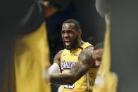Los Angeles Lakers' LeBron James talks to teammates during a timeout in the first half of an NBA basketball game against the Brooklyn Nets Thursday, Jan. 23, 2020, in New York. (AP Photo/Frank Franklin II)