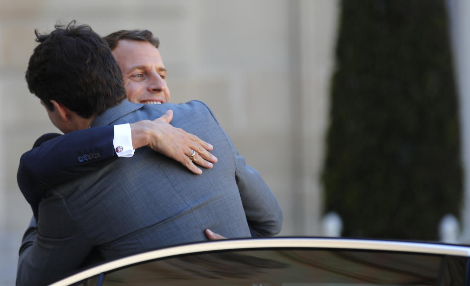 French President Emmanuel Macron, right, greets Canada's Prime Minister Justin Trudeau during arrivals at the Elysee Palace, in Paris, Wednesday, May 15, 2019. Several world leaders and tech bosses are meeting in Paris to find ways to stop acts of violent extremism from being shown online.(AP Photo/Francois Mori)