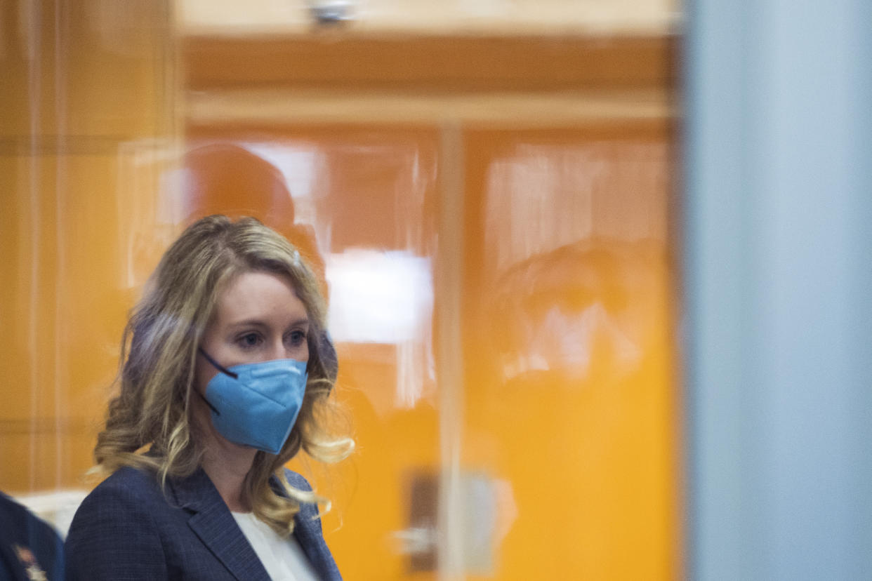 Elizabeth Holmes walks into federal court in San Jose, Calif., Friday, Dec. 17, 2021. The lawyers for the opposing sides in the trial of former Theranos CEO are expected to wrap up their closing arguments Friday, paving the way for a jury to begin their deliberations over criminal charges accusing her of turning her blood-testing startup into a massive scam. (AP Photo/Nic Coury)