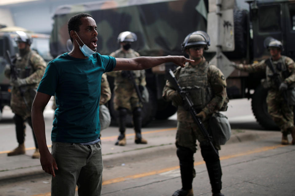 A man gestures as he confronts National Guard members guarding the area in the aftermath of a protest in Minneapolis