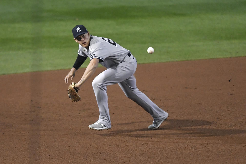 New York Yankees third baseman Gio Urshela fields a ground ball by Toronto Blue Jays' Teoscar Hernandez before throwing home during the fourth inning of a baseball game in Buffalo, N.Y., Monday, Sept. 21, 2020. Jonathan Davis was safe at home and Hernandez was safe at first. (AP Photo/Adrian Kraus)