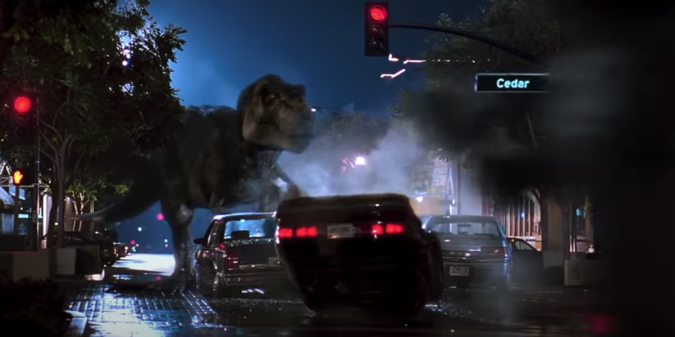 A T-Rex walks down the street