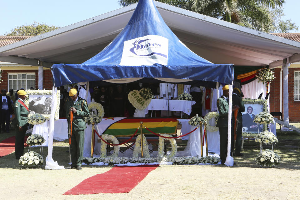 The coffin carrying the body of former Zimbabwean President Robert Mugabe is seen during mass at his rural home in Zvimba, about 100 kilometers north west of the capital Harare, Saturday. Sept, 28, 2019. According to a family spokesperson Mugabe is expected to be buried at the residence after weeks of drama mystery and contention over his burial place. (AP Photo/Tsvangirayi Mukwazhi)