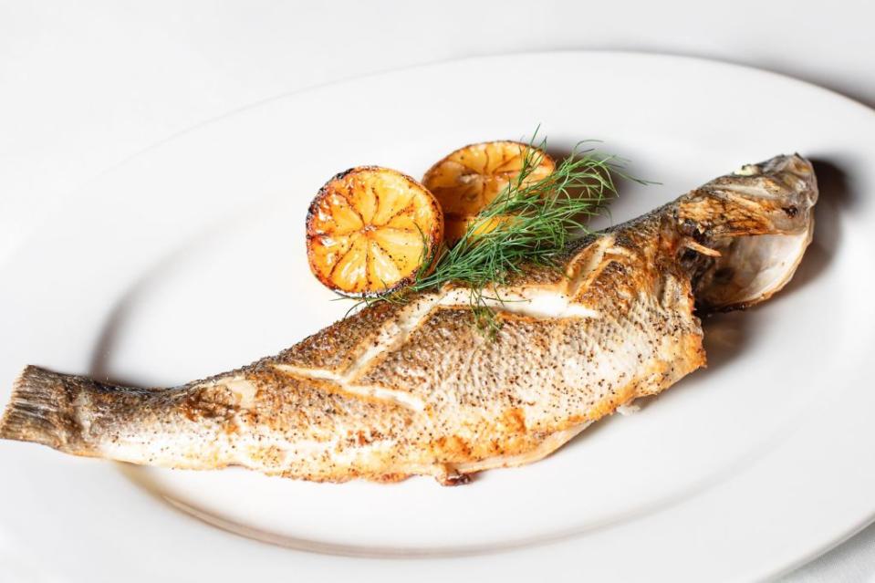 Consider swapping turkey and gravy for Mediterranean mains such as grilled branzino to avoid the immune-triggering effects of tryptophan. Shutterstock