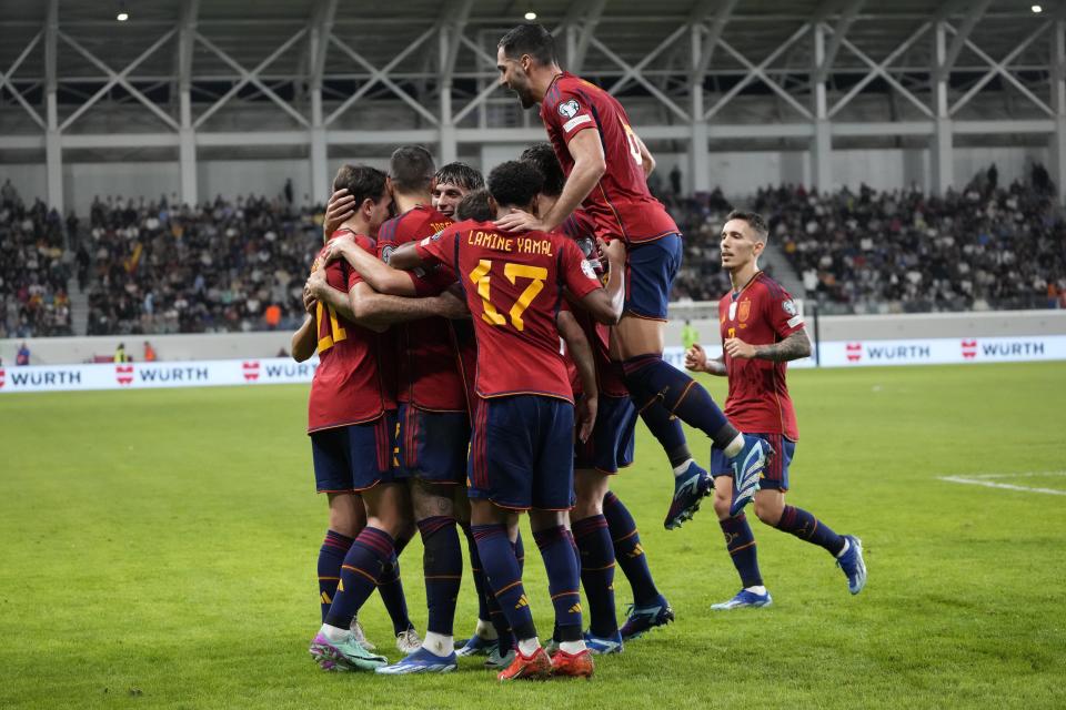 Spain's Joselu celebrates with his teammates after scoring his sides third goal during an Euro 2024 group A qualifying soccer match between Cyprus and Spain, at the Alphamega Stadium stadium in Limassol, Cyprus Thursday, Nov. 16, 2023. (AP Photo/Petros Karadjias)