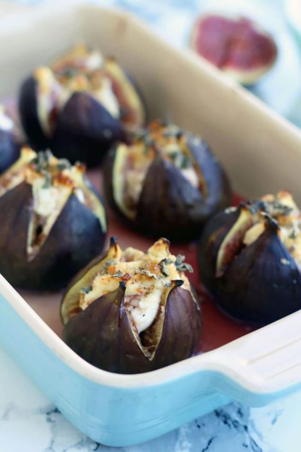 <p>Take advantage of fig season by baking these open-faced bites with cheese, walnuts, honey, and sage.</p><p><strong>Get the recipe at </strong><strong><a href="https://happykitchen.rocks/baked-figs-goat-cheese/" rel="nofollow noopener" target="_blank" data-ylk="slk:Happy Kitchen Rocks;elm:context_link;itc:0;sec:content-canvas" class="link ">Happy Kitchen Rocks</a>. </strong></p>