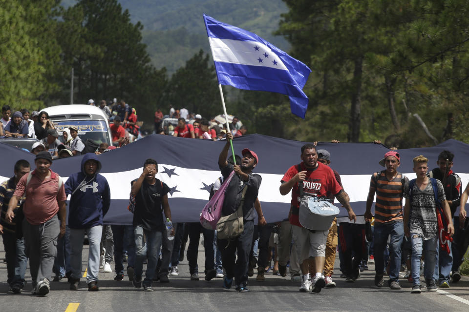 Hondurans march in a caravan of migrants moving toward the country's border with Guatemala in a desperate attempt to flee poverty and seek new lives in the United States, in Ocotepeque, Honduras, Monday, Oct. 15, 2018. The group has grown to an estimated 1,600 people from an initial 160 who first gathered early Friday in a northern Honduras city. They plan to try to enter Guatemala on Monday. (AP Photo/Moises Castillo)