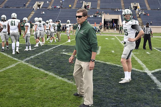 <p>Ron Waite/CSM/Shutterstock</p> Dartmouth Head Coach, Buddy Teevens watches his team warmup during the NCAA football game between the Dartmouth Big Green and Yale Bulldogs at the Yale Bowl in New Haven Connecticut.