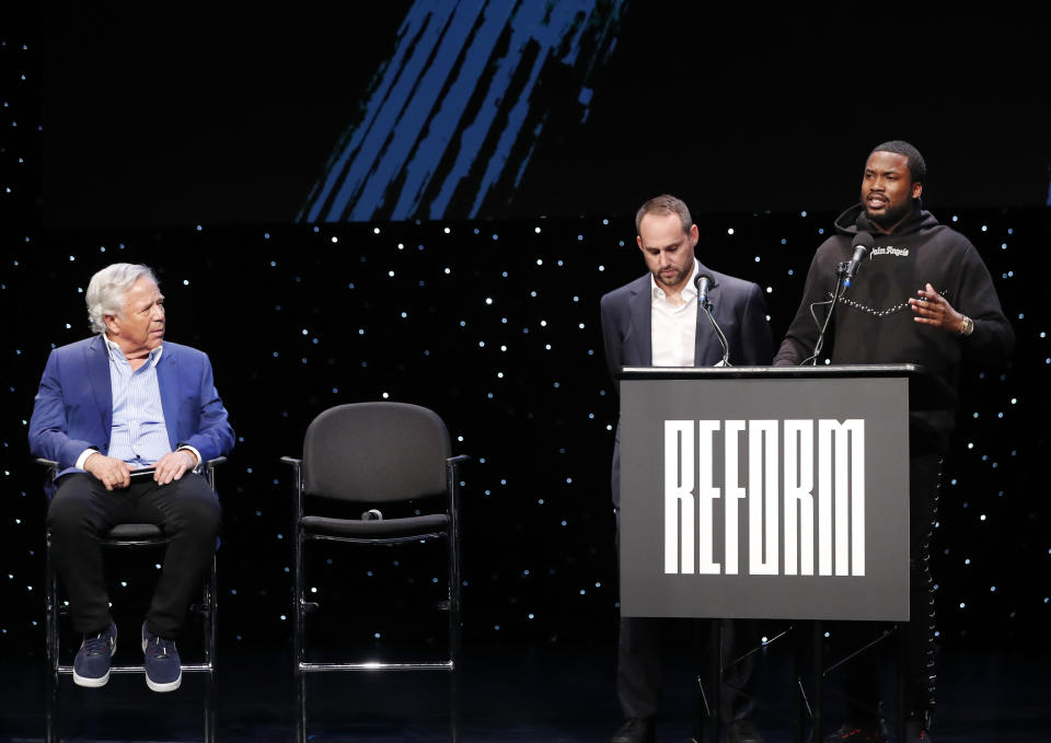 New England Patriots owner Robert Kraft, left, and Philadelphia 76ers owner and Fanatics executive chairman Michael Rubin, second from left, listen to recording artist Meek Mill talk abut being incarcerated at the launch of Reform Alliance, a partnership among entertainment moguls, recording artists, business and sports leaders who hope to transform the American criminal justice system, Wednesday, Jan. 23, 2019, in New York. (AP Photo/Kathy Willens)