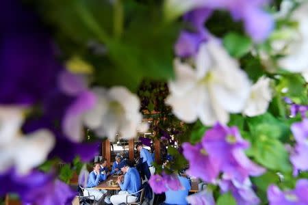 Tennis - Wimbledon - All England Lawn Tennis and Croquet Club, London, Britain - July 2, 2018 Match officials eat lunch. REUTERS/Toby Melville