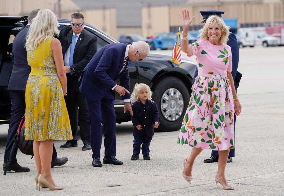 First lady Jill Biden waves as President Joe Biden looks at grandson Beau Biden as they prepare to board Air Force One at Andrews Air Force Base, Md., Aug. 10, 2022. The family traveled to Kiawah Island, S.C., for vacation.