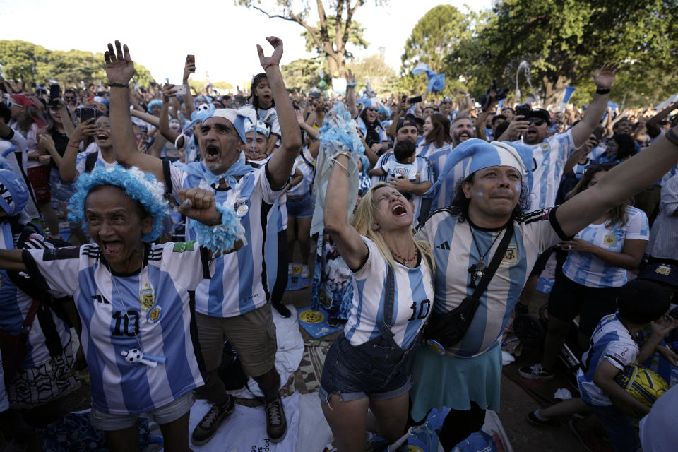 Argentina soccer fans celebrate their team's victory over Croatia as they watch the team's World Cup semifinal match in Qatar on a screen set up in the Palermo neighborhood of Buenos Aires, Argentina, Tuesday, Dec. 13, 2022. (AP Photo/Rodrigo Abd)