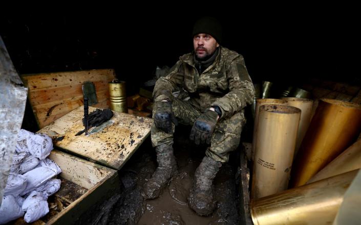 A Ukrainian serviceman of a fire platoon sits inside a hiding of a trench near the frontline - LISI NIESNER/REUTERS