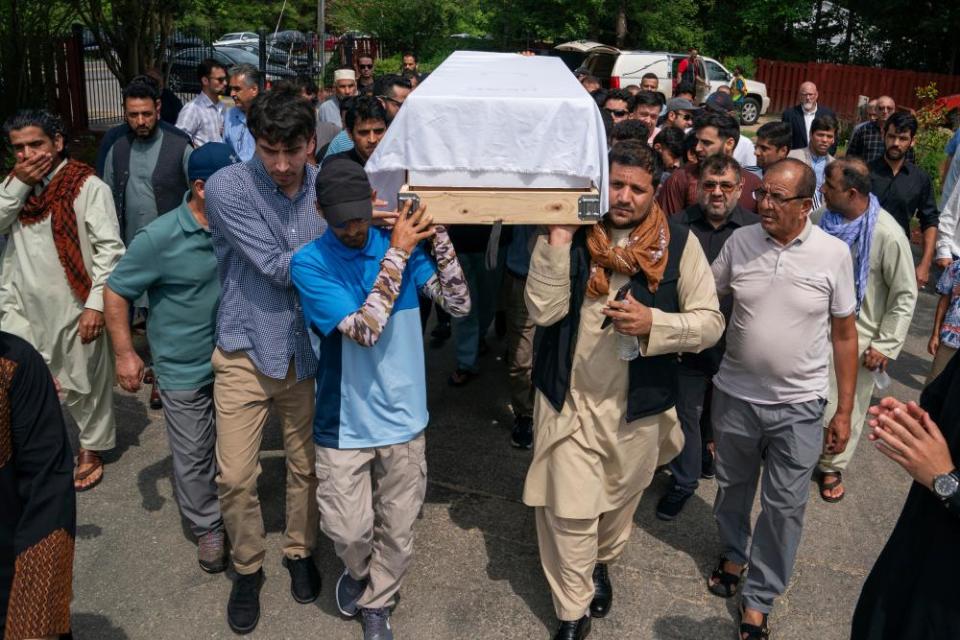 Friends and family carry coffin