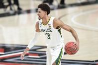 Baylor's MaCio Teague (31) controls the ball during the first half of an NCAA college basketball game against Texas Tech in Lubbock, Texas, Saturday, Jan. 16, 2021. (AP Photo/Justin Rex)