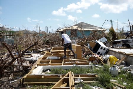 A man walks among the debris of his house after Hurricane Dorian hit the Abaco Islands in Spring City