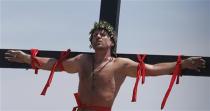 Danish filmmaker Lasse Spang Olsen utters words as he is crucified on a wooden cross during a Good Friday ritual of the re-enactment of the death of Jesus Christ in San Fernando, Pampanga in northern Philippines April 18, 2014. REUTERS/Erik De Castro