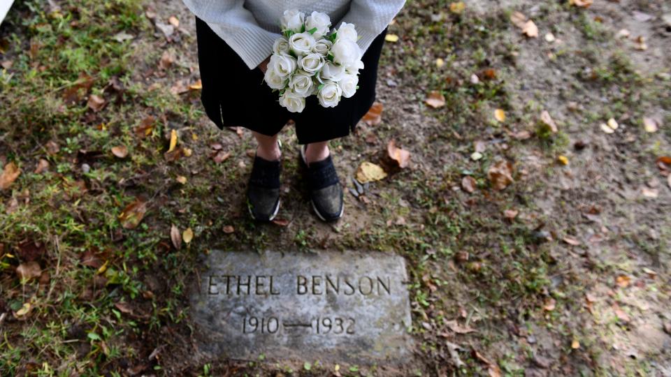 A relative of Ethel Benson brings flowers to Benson's headstone located in the Stockley Center Cemetery in Georgetown, Delaware. Benson was sterilized in 1932 and died weeks later.