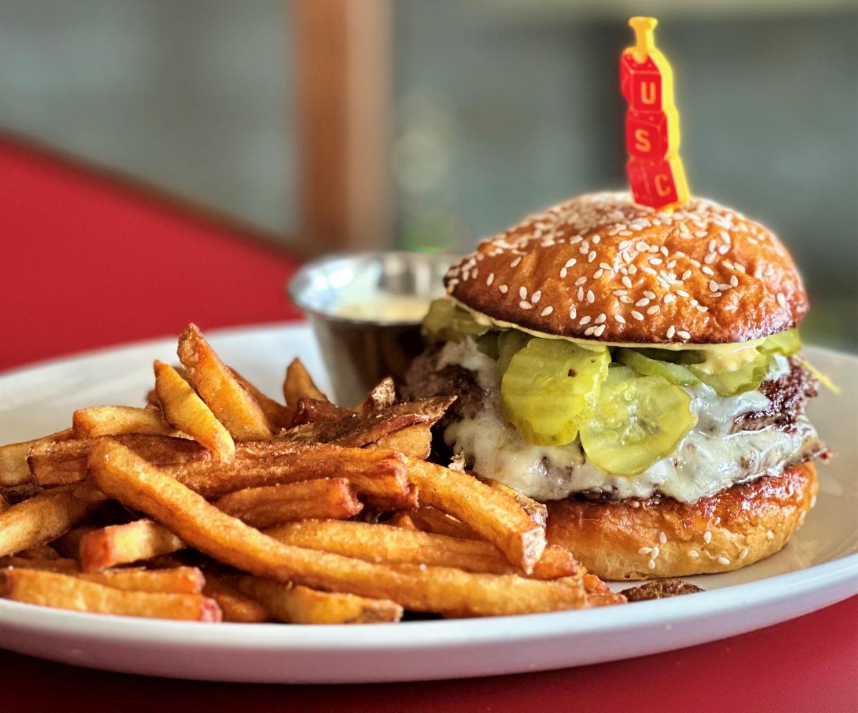 Ever wondered what a cheeseburger designed by barbecue wizard Aaron Franklin would taste like? You can find out in the evenings at Uptown Sports Club.