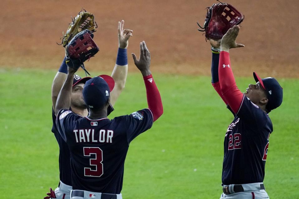 Washington Nationals' Gerardo Parra, Michael A. Taylor and Juan Soto celebrate after Game 2 of the baseball World Series against the Houston Astros Thursday, Oct. 24, 2019, in Houston. The Nationals won 12-3 to take a 2-0 lead in the series. (AP Photo/Eric Gay)