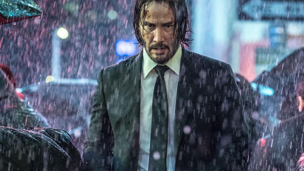  Keanu Reeves as John Wick, walking through a rainy street, in John Wick: Chapter 3 - Parabellum. 