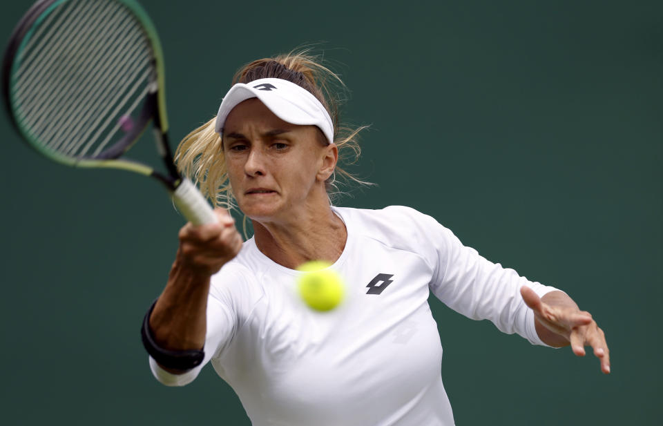 Ukraine's Lesia Tsurenko returns to Britain's Jodie Burrage during a women's singles first round match on day one of the Wimbledon tennis championships in London, Monday, June 27, 2022. (Steve Paston/PA via AP)