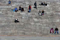 FILE PHOTO: People sit on the steps of Helsinki Cathedral on a sunny day in Helsinki, Finland, May 3, 2017. REUTERS/Ints Kalnins/File Photo