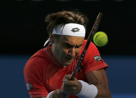 David Ferrer of Spain hits a return to Kei Nishikori of Japan during their men's singles fourth round match at the Australian Open 2015 tennis tournament in Melbourne January 26, 2015. REUTERS/Athit Perawongmetha