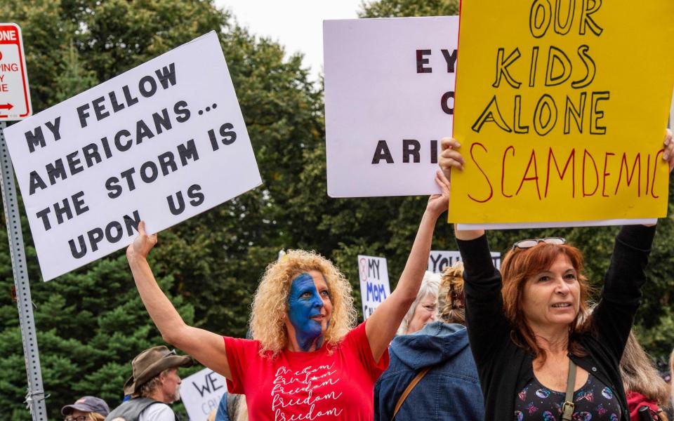 Demonstrators gather outside the Massachusetts State House in Boston to protest Covid-19 vaccination and mask mandates. - AFP