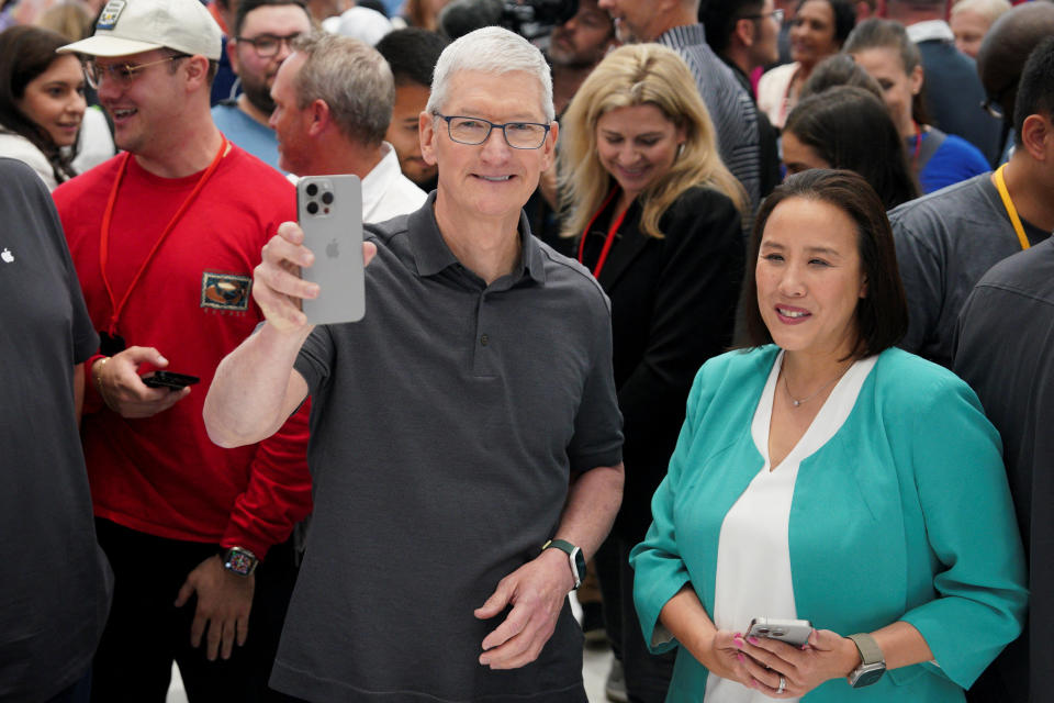 Apple CEO Tim Cook holds a new iPhone 15 Pro during the 'Wonderlust' event at the company's headquarters in Cupertino, California, U.S. September 12, 2023. REUTERS/Loren Elliott