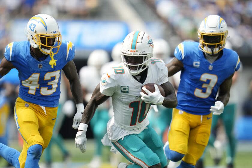 Miami Dolphins wide receiver Tyreek Hill (10) is pursued by Los Angeles Chargers cornerback Michael Davis (43) and safety Derwin James Jr. (3) during the first half of an NFL football game Sunday, Sept. 10, 2023, in Inglewood, Calif. (AP Photo/Ashley Landis)