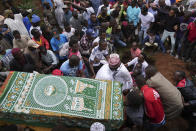 Relatives carry the body of 19-year-old Ibrahim Kamau for burial, at the Kariakor cemetery in Nairobi, Kenya Friday, June 28, 2024. Kamau was shot during a protest on Tuesday against the government proposed tax bill. Protesters stormed parliament on Tuesday and drew police fire in chaos that left several people dead. (AP Photo/Brian Inganga)