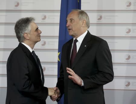 Latvian President Andris Berzins welcomes Austrian Chancellor Werner Faymann (L) at the Eastern Partnership Summit in Riga, Latvia, May 21, 2015. REUTERS/Ints Kalnins