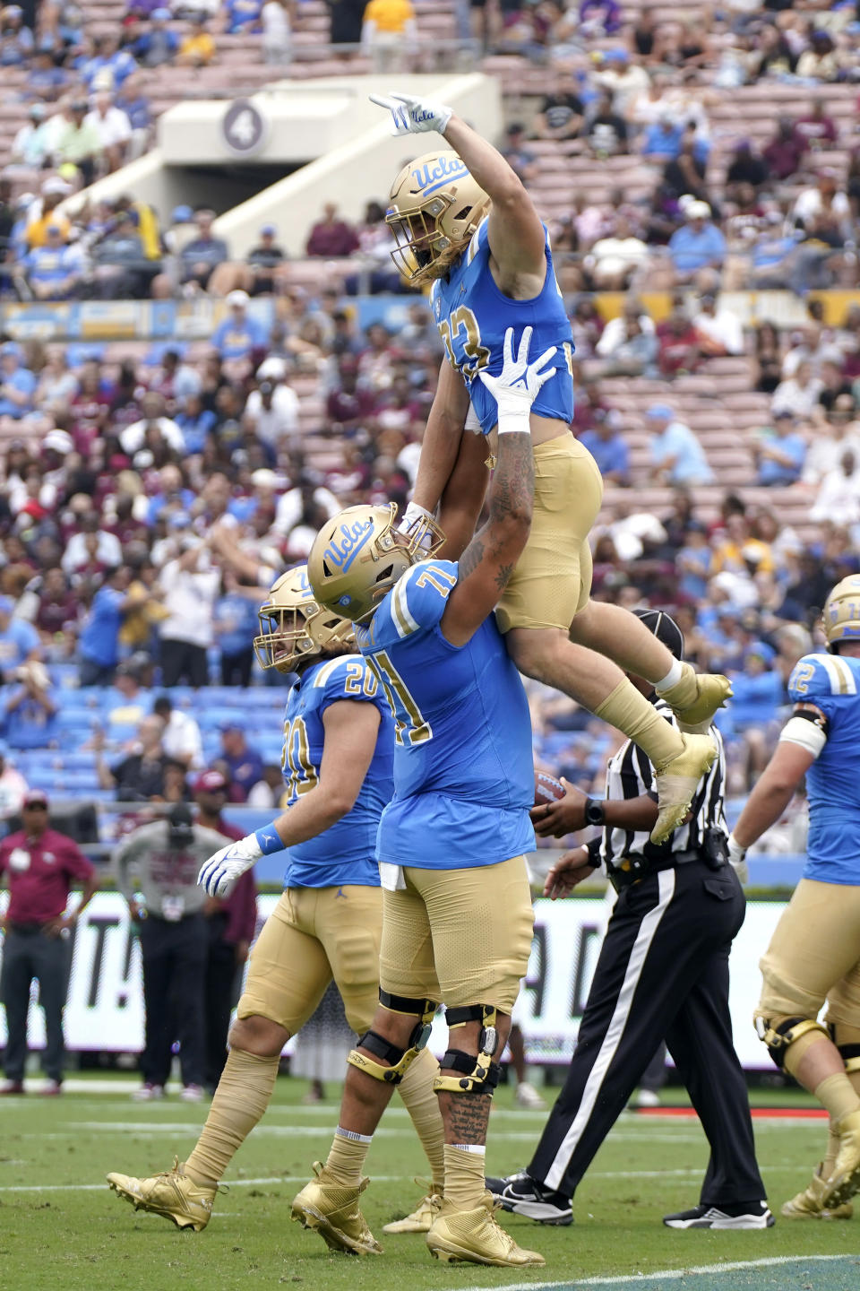 UCLA running back Carson Steele, top, celebrates his touchdown with offensive lineman Jake Wiley during the first half of an NCAA college football game against North Carolina Central Saturday, Sept. 16, 2023, in Pasadena, Calif. (AP Photo/Mark J. Terrill)