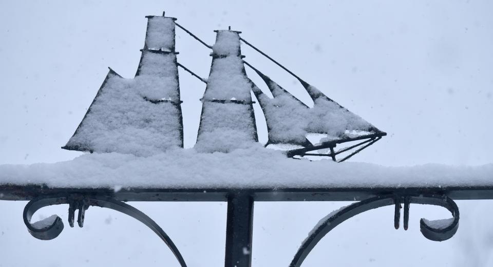 The tall ship outside the Coast Guard Museum in Barnstable gathers a snow coat on its sails along Route 6A in Barnstable on Feb. 28.