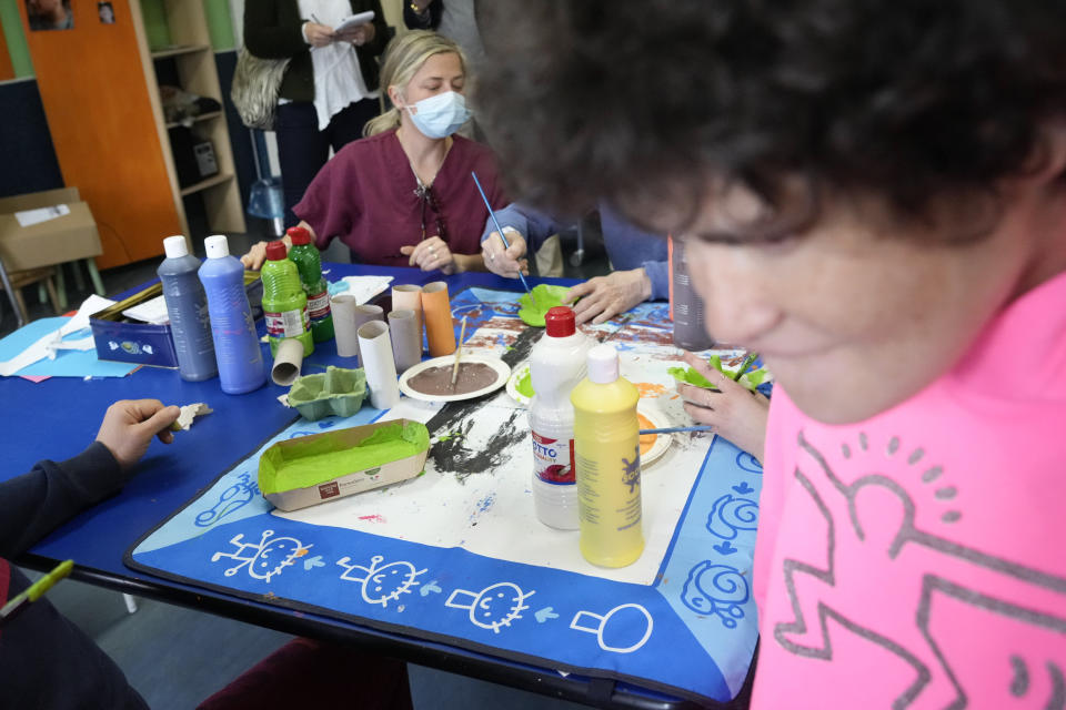 People works with collars in a laboratory of the Chicco community of L'Arche, an International charity that helps people with intellectual disabilities, in Ciampino, near Rome, Wednesday, March 22, 2023. The findings of expert reports commissioned by L’Arche itself reveal that their founder, Jean Vanier, perverted Catholic doctrine to justify his own sexual compulsions and abuse women and that the movement he created had at its core a secret, a mystical-sexual “sect” founded for the precise purpose of hiding the sect’s deviant activities from church authorities. (AP Photo/Gregorio Borgia)