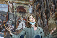 Vatican Museums director Barbara Jatta speaks to the media as she stands in front of Raphael's oil painted feminine figure known as 'Allegory of Justice', left, in the Constantine Hall at the Vatican Museums, Wednesday, May 3, 2020.The Vatican Museums announced last month that after restorations they have determined that two of the female figures in the Hall of Constantine were painted in oil by Raphael himself and not by his workshop. (AP Photo/Domenico Stinellis)