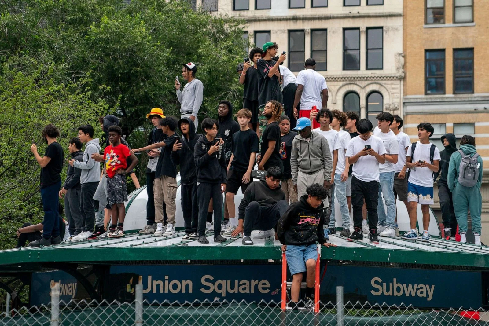 PHOTO: People stand on top of a subway station entrance after popular live streamer Kai Cenat announced a 'giveaway' event at Union Square in New York City, Aug. 4, 2023. (David Dee Delgado/Reuters)