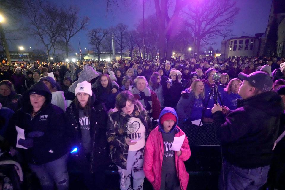 People sing “Lean On Me” at the conclusion of a one-year remembrance ceremony for the Christmas Parade tragedy in at Cutler Park Waukesha on Monday, Nov. 21, 2022. One year ago Darrell Brooks drove his SUV through the downtown parade killing six people and injuring dozens more.