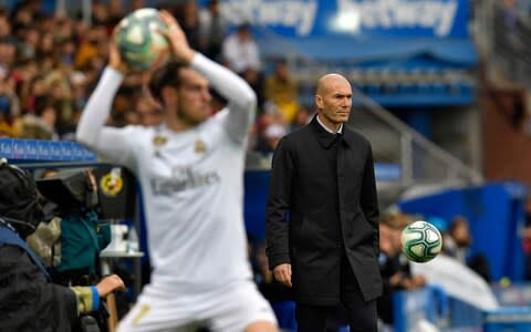 Zinedine Zidane watches Gareth Bale take a throw-in - Credit: ap