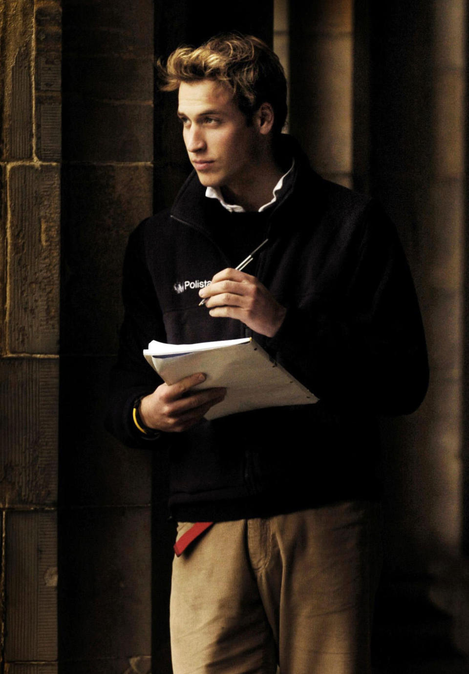 FILE - Britain's Prince William pauses in St Salvator's Quad at St Andrews University where he is a student in St Andrews Scotland Monday Nov. 15, 2004. The world watched as Prince William grew from a towheaded schoolboy to a dashing air-sea rescue pilot to a father of three. But as he turns 40 on Tuesday, June 21, 2022, William is making the biggest change yet: assuming an increasingly central role in the royal family as he prepares for his eventual accession to the throne. (David Cheskin, Pool via AP, File)