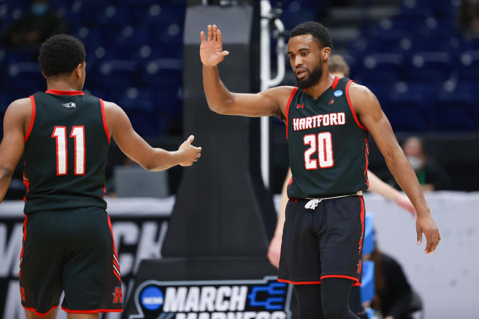 INDIANAPOLIS, IN - MARCH 19: Austin Williams #20 of the Hartford Hawks reacts to a play during the game against the Baylor Bears in the first round of the 2021 NCAA Division I Mens Basketball Tournament held at Lucas Oil Stadium on March 19, 2021 in Indianapolis, Indiana. (Photo by Justin Tafoya/NCAA Photos via Getty Images)