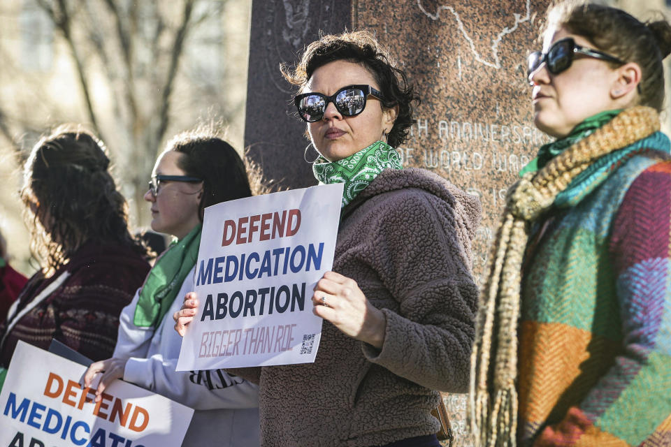 Image: Lindsay London holds a sign in support of access to abortion medication, outside the Federal Courthouse on March 15, 2023 in Amarillo, Texas.  (David Erickson / AP)