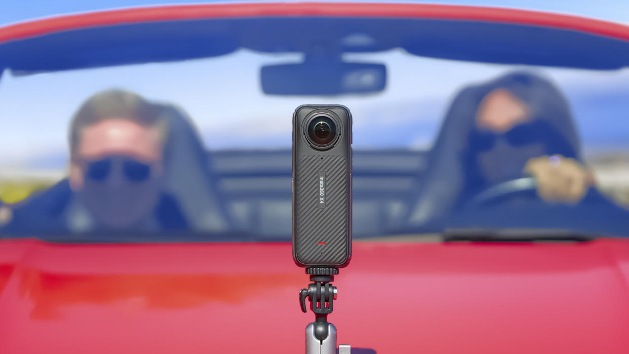  Insta360 X4 360 degree camera mounted to a red convertible car's bonnet. 
