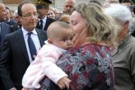 French President Francois Hollande (left) speaks with with a woman holding her baby in Dieudonne, north of Paris, this week. Fresh from his victory last month over right-winger Nicolas Sarkozy, Hollande is set to consolidate his hold on power as he seeks to navigate France through Europe's financial crisis, rising joblessness and a stagnant economy