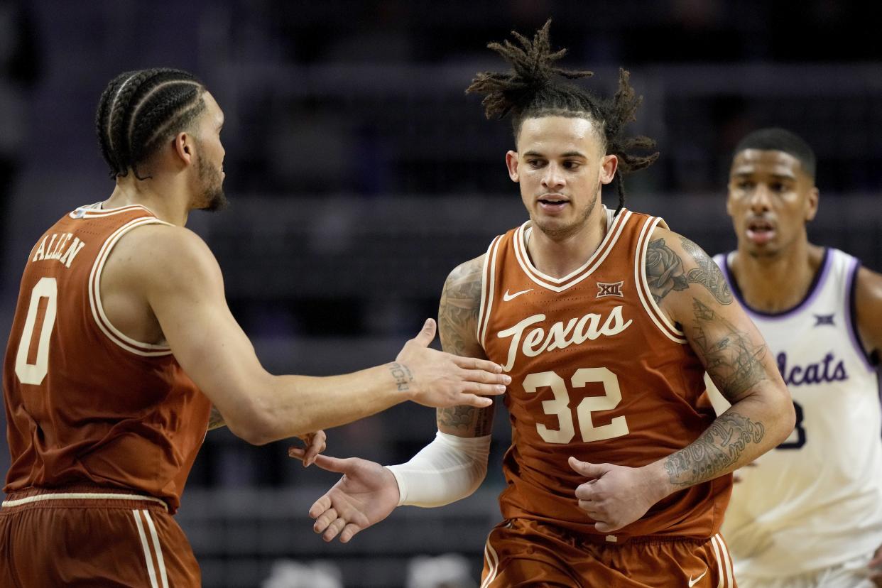 Texas forward Timmy Allen congratulates Christian Bishop after a basket in Saturday's 69-66 win over Kansas State. Bishop scored 14 points in the second half to pace the Longhorns, who remained alone atop the Big 12 standings.