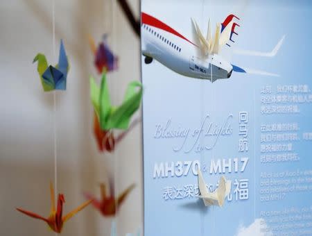 A memorial to the victims of both flights MH370 and MH17 is set up at the Xiao En Bereavement Centre in Kuala Lumpur September 9, 2014. Malaysia Airlines (MAS) Flight MH370 carrying 239 passengers and crew, disappeared on March 8 after taking off from Malaysia's capital, Kuala Lumpur, bound for Beijing. Malaysia Airlines Flight MH17 crashed after being shot down over war-torn Ukraine on July 17, killing all 298 people on board. REUTERS/Olivia Harris