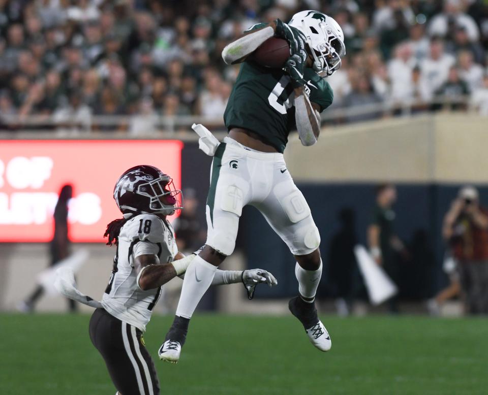 MSU WR Keon Coleman grabs a pass against WMU CB Kerni-H Lovely, Friday, Sept. 2, 2022, during the season opener at Spartan Stadium.