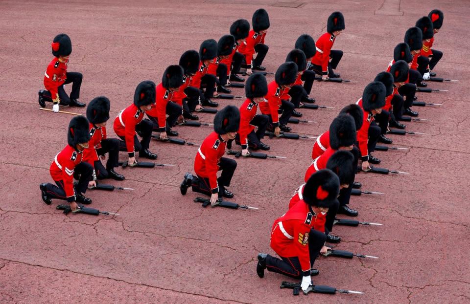 Members of the Coldstream guards kneel and place their rifles on the ground before cheering as the Principal Proclamation is read (Richard Heathcote/PA) (PA Wire)